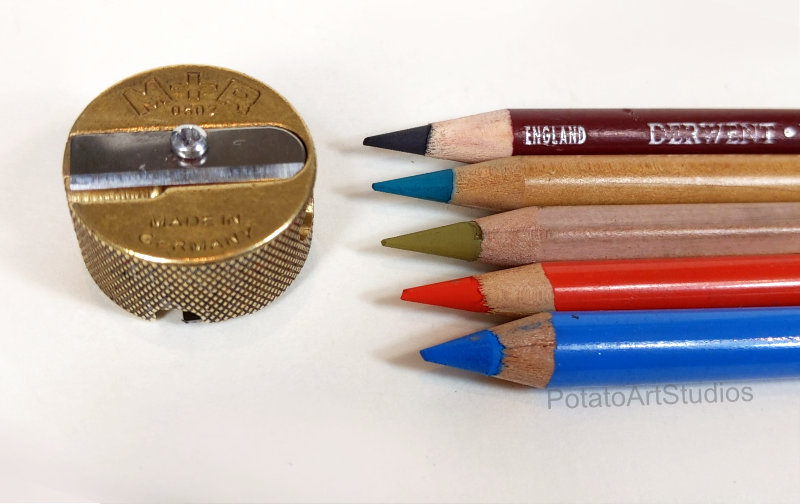 Mobius & Ruppert 602 sharpener next to Derwent, Faber-Castell PITT, Caran d'Ache, Stabilo CarbOthello, and Conte a Paris pastel pencils.